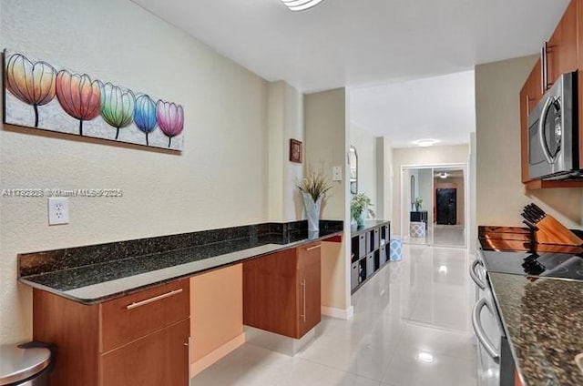 interior space featuring light tile patterned floors and stainless steel appliances