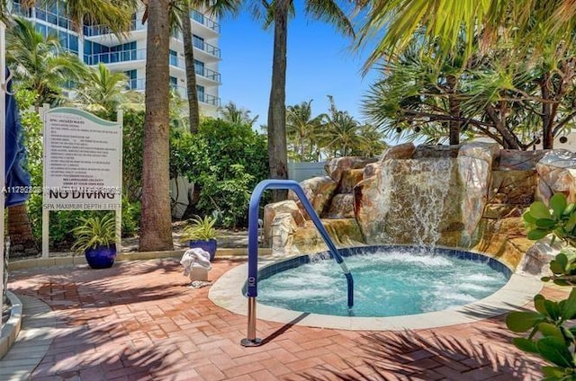 view of swimming pool with a patio and a community hot tub