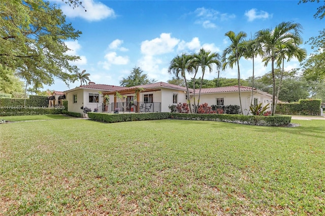 1402 Tangier St, Coral Gables, FL 33134 - view of front facade with a tile roof, stucco siding, and a front yard
