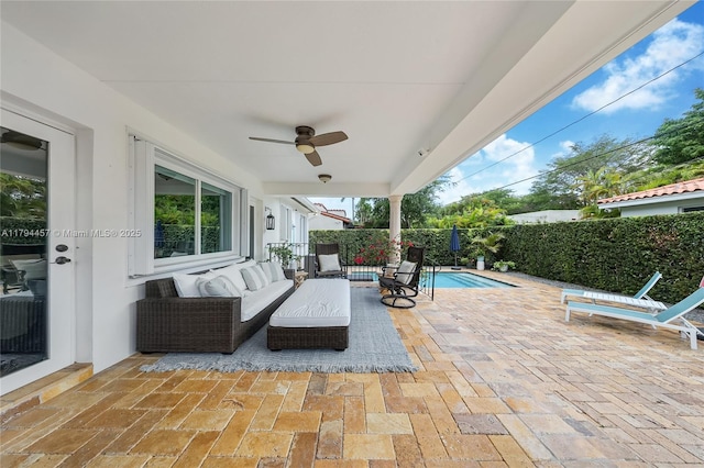 view of patio with an outdoor living space, a ceiling fan, a fenced backyard, and a fenced in pool