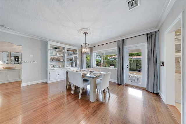 1402 Tangier St, Coral Gables, FL 33134 - dining space with ornamental molding, light wood finished floors, and a chandelier
