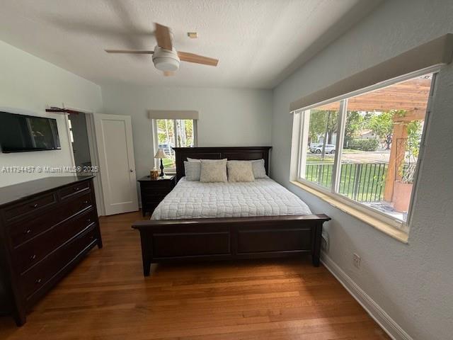 1402 Tangier St, Coral Gables, FL 33134 - bedroom featuring wood finished floors and ceiling fan