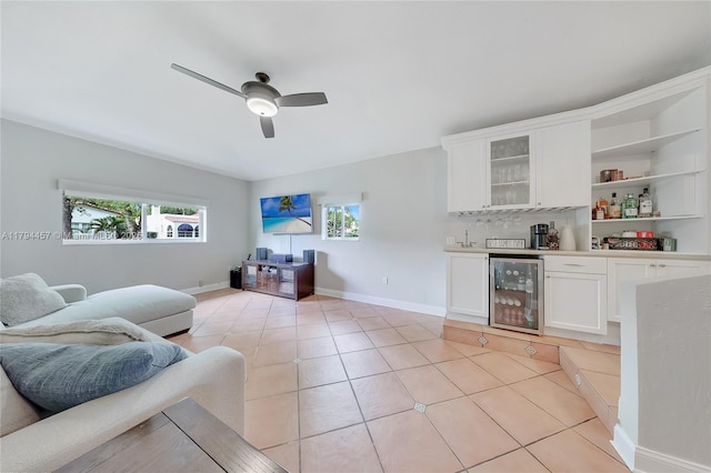 living room featuring wine cooler, plenty of natural light, a bar, and ceiling fan