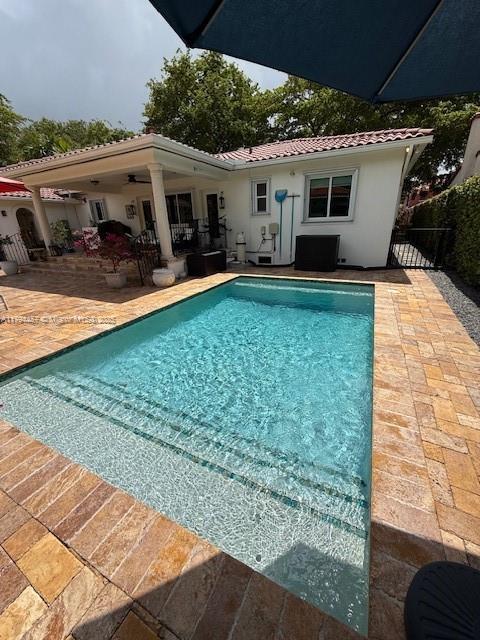 1402 Tangier St, Coral Gables, FL 33134 - swimming pool featuring a patio area and ceiling fan