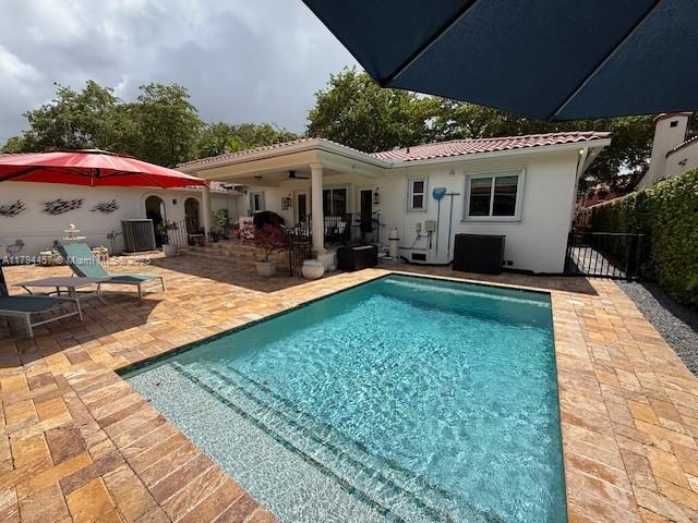 1402 Tangier St, Coral Gables, FL 33134 - back of house with a patio area, stucco siding, and a tiled roof