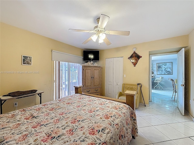 bedroom featuring light tile patterned flooring, ceiling fan, and a closet