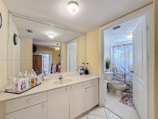 bathroom featuring a textured ceiling, visible vents, tile patterned floors, vanity, and toilet