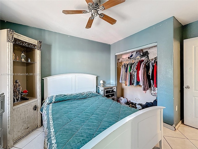 bedroom featuring light tile patterned floors, ceiling fan, and a closet