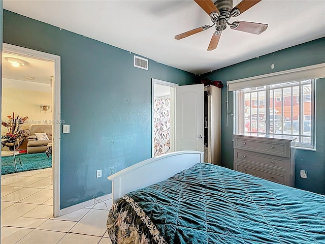 bedroom featuring visible vents, ceiling fan, and light tile patterned floors