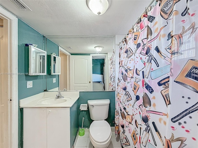 bathroom with a textured ceiling, visible vents, tile patterned flooring, vanity, and toilet
