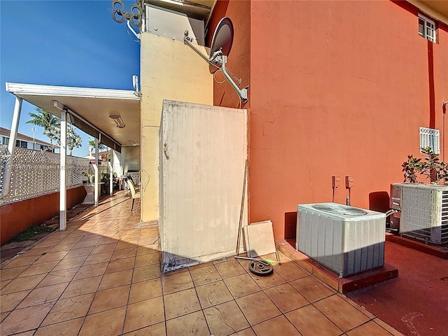 view of patio with fence and central AC unit