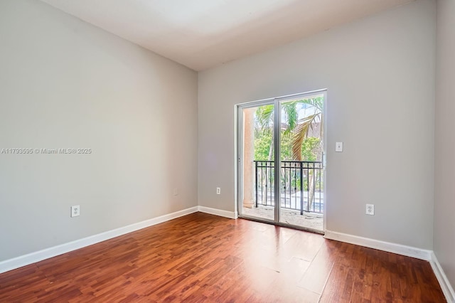 empty room featuring baseboards and wood finished floors