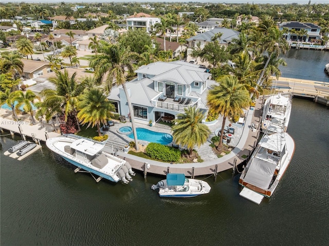 drone / aerial view featuring a residential view and a water view