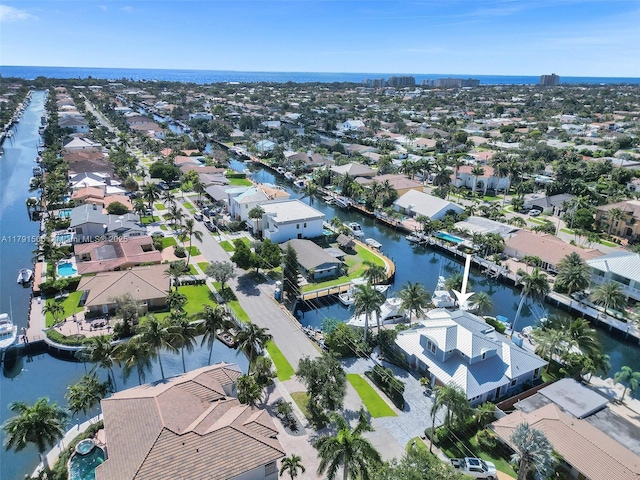 drone / aerial view with a water view and a residential view