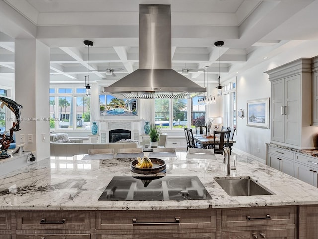 kitchen featuring black electric cooktop, island range hood, a sink, and coffered ceiling