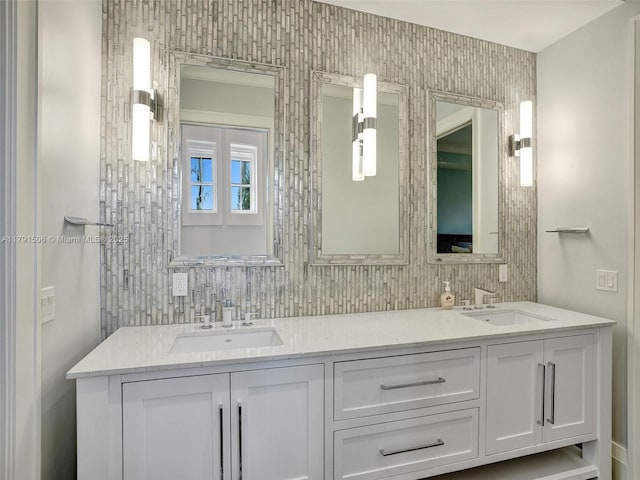 full bath featuring a sink, tasteful backsplash, and double vanity