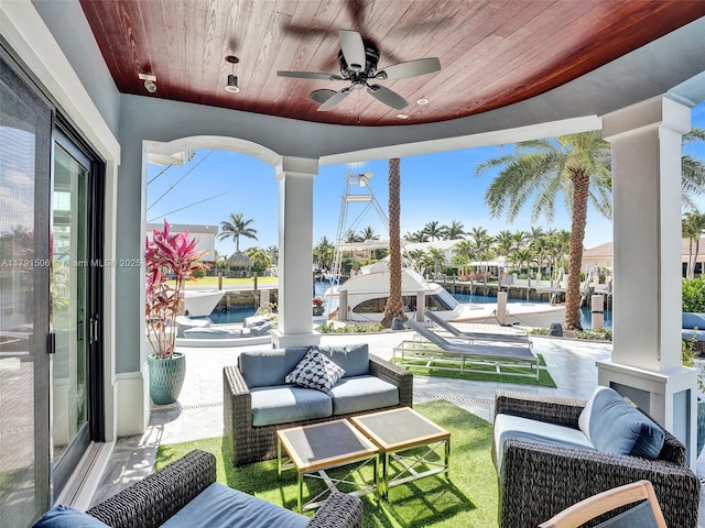view of patio featuring an outdoor living space, a water view, and ceiling fan