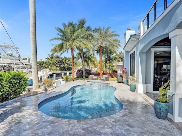 view of pool with a patio, a pool with connected hot tub, and fence