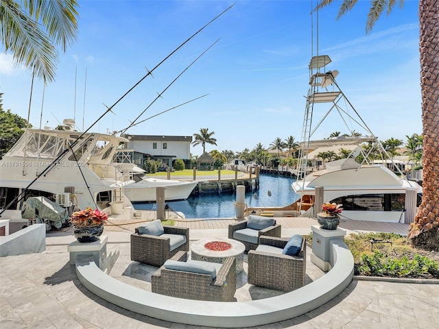 view of patio with a boat dock, a fire pit, boat lift, and a water view
