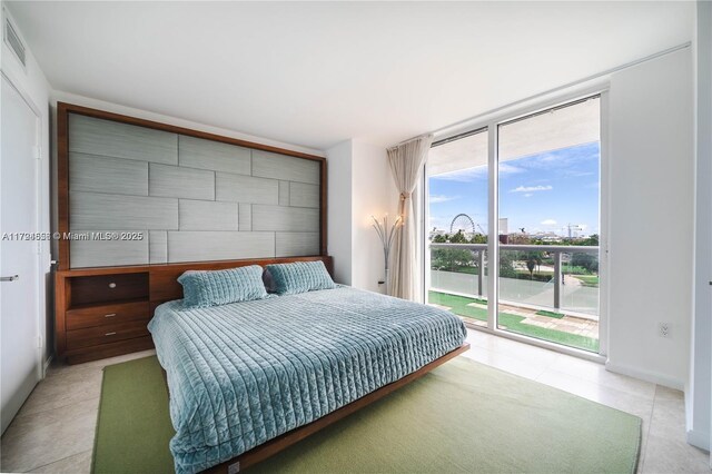 50 Biscayne Blvd Unit 602, Miami, FL 33132 - bedroom with access to exterior, a wall of windows, and light tile patterned floors