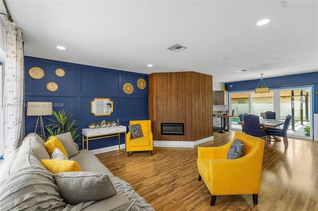 6690 Miramar Pkwy, Miramar, FL 33023 - living area with a decorative wall, wood finished floors, and recessed lighting