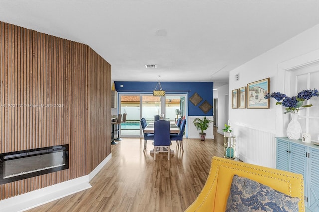 6690 Miramar Pkwy, Miramar, FL 33023 - dining space featuring wood finished floors and a glass covered fireplace