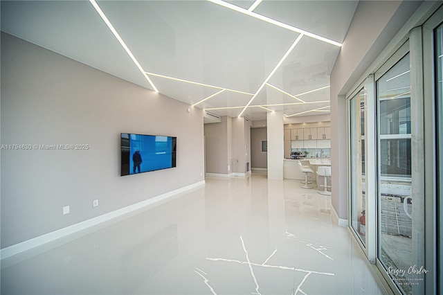 interior space featuring baseboards and light tile patterned floors