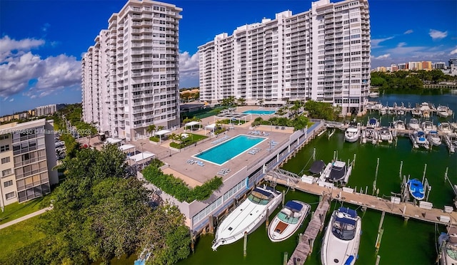 birds eye view of property with a water view and a city view