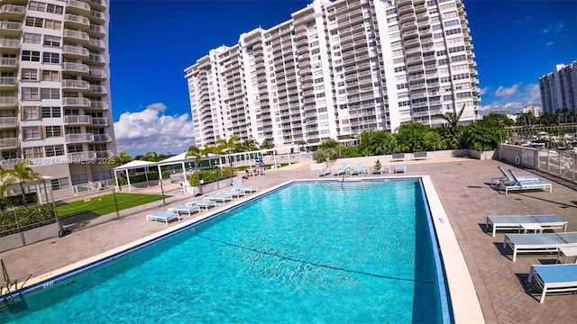 community pool featuring a patio and fence