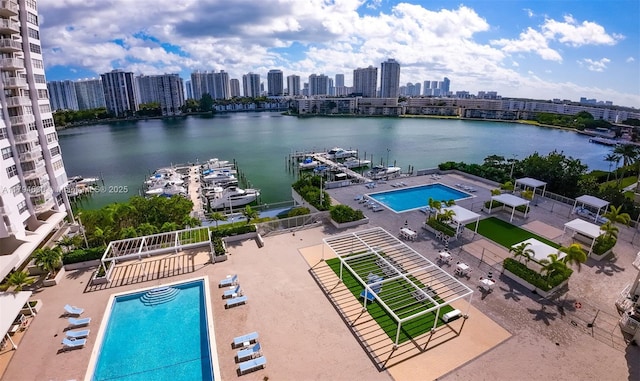 birds eye view of property featuring a city view and a water view