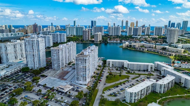 birds eye view of property with a water view and a city view