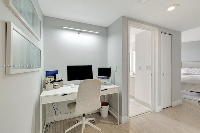 home office featuring recessed lighting, baseboards, and wood finished floors
