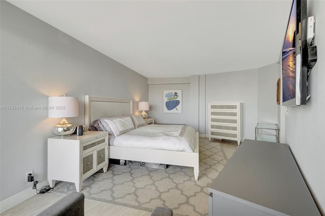 bedroom featuring baseboards and light wood-type flooring