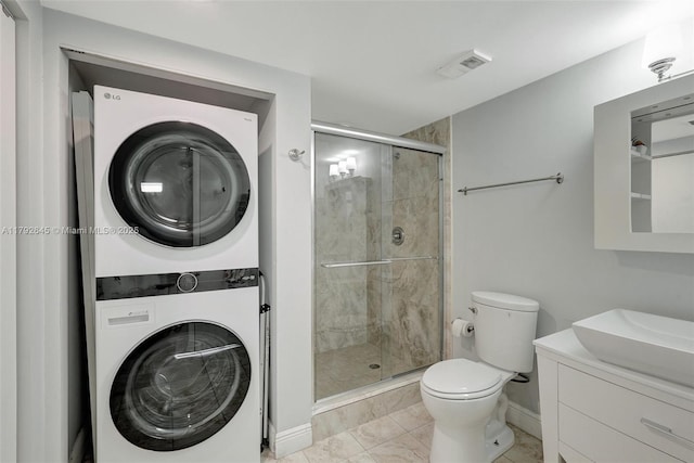 full bathroom with visible vents, stacked washer / drying machine, a shower stall, baseboards, and toilet