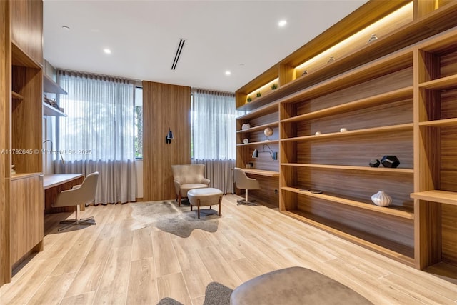 sitting room with light wood-style floors and built in study area