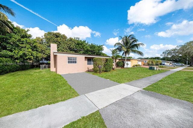 2821 N 74th Ave, Hollywood, FL 33024 - ranch-style house featuring a front lawn, asphalt driveway, and stucco siding