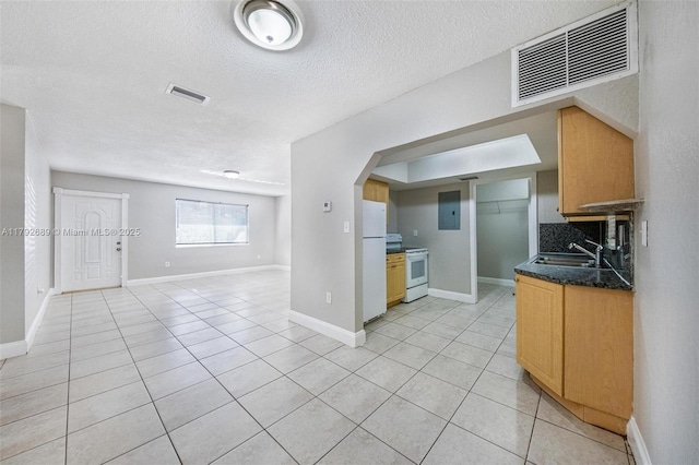 2821 N 74th Ave, Hollywood, FL 33024 - kitchen featuring a sink, white appliances, open floor plan, light tile patterned floors, and a textured ceiling