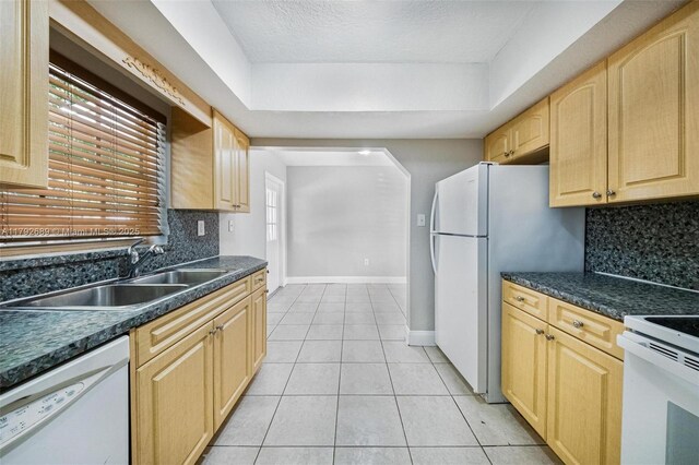 2821 N 74th Ave, Hollywood, FL 33024 - kitchen with white appliances, a sink, backsplash, light brown cabinets, and a textured ceiling