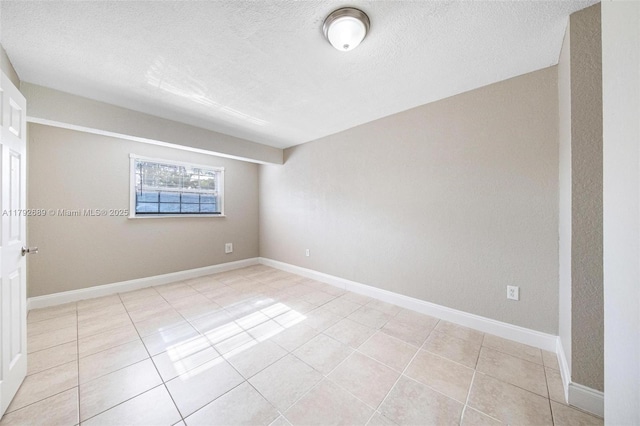 2821 N 74th Ave, Hollywood, FL 33024 - unfurnished room with a textured ceiling, light tile patterned floors, and baseboards