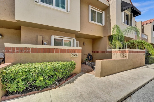 doorway to property with stucco siding