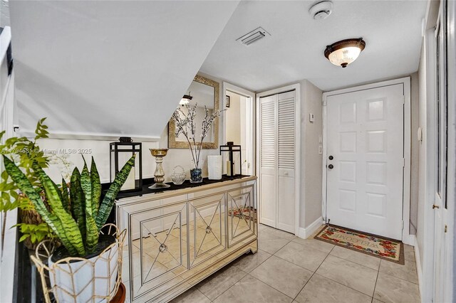 entrance foyer featuring visible vents, baseboards, and light tile patterned flooring