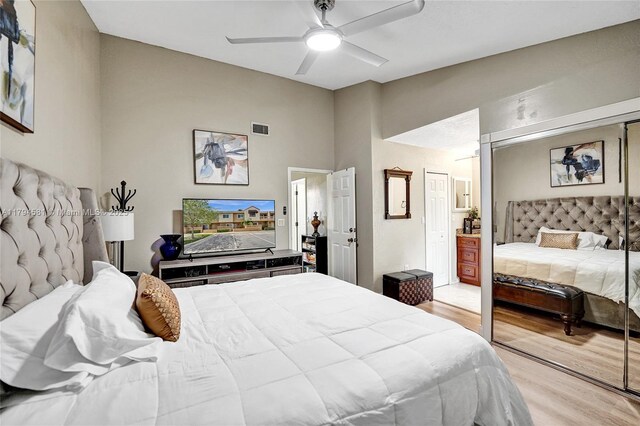 bedroom with ceiling fan, light wood finished floors, and visible vents