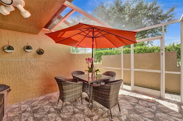sunroom with outdoor dining area