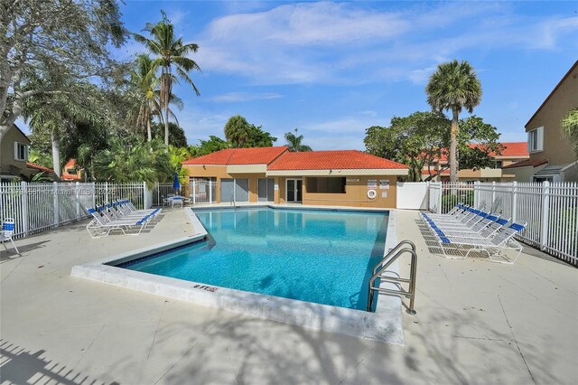 pool featuring fence and a patio area