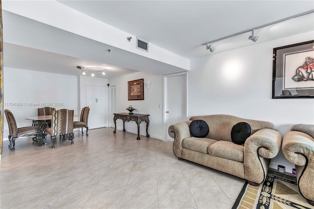 living room with light tile patterned flooring, rail lighting, and visible vents