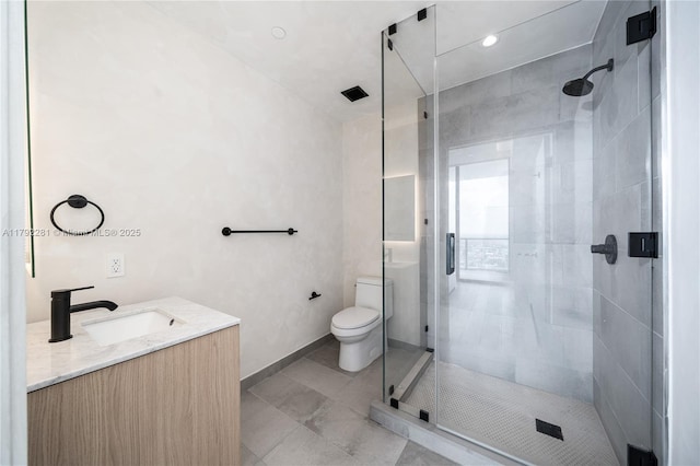 full bathroom featuring toilet, a shower stall, and vanity