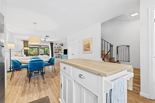 450 SE 7th St Unit 234, Dania Beach, FL 33004 - kitchen featuring a ceiling fan, wooden counters, white cabinets, open floor plan, and light wood-style flooring