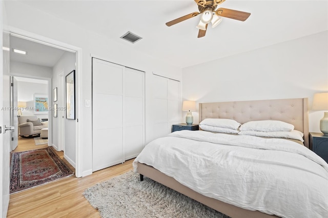 450 SE 7th St Unit 234, Dania Beach, FL 33004 - bedroom with multiple closets, a ceiling fan, light wood-style flooring, and visible vents