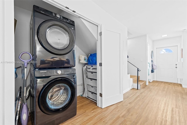 450 SE 7th St Unit 234, Dania Beach, FL 33004 - laundry room with baseboards, laundry area, stacked washer / dryer, and wood finished floors