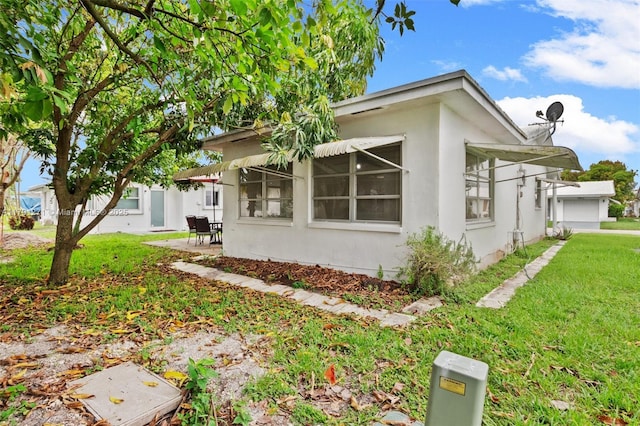 5810 NW 82nd Ter, Tamarac, FL 33321 - view of property exterior with a yard, a patio, and stucco siding